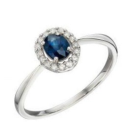White gold cluster ring with diamonds and blue sapphire stone